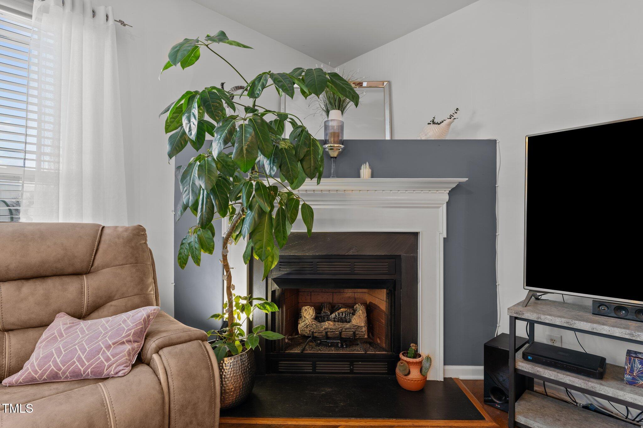 4027 Comrie Lane Burlington, NC 27215 - Photo 11 of 47 a living room with furniture and a fireplace