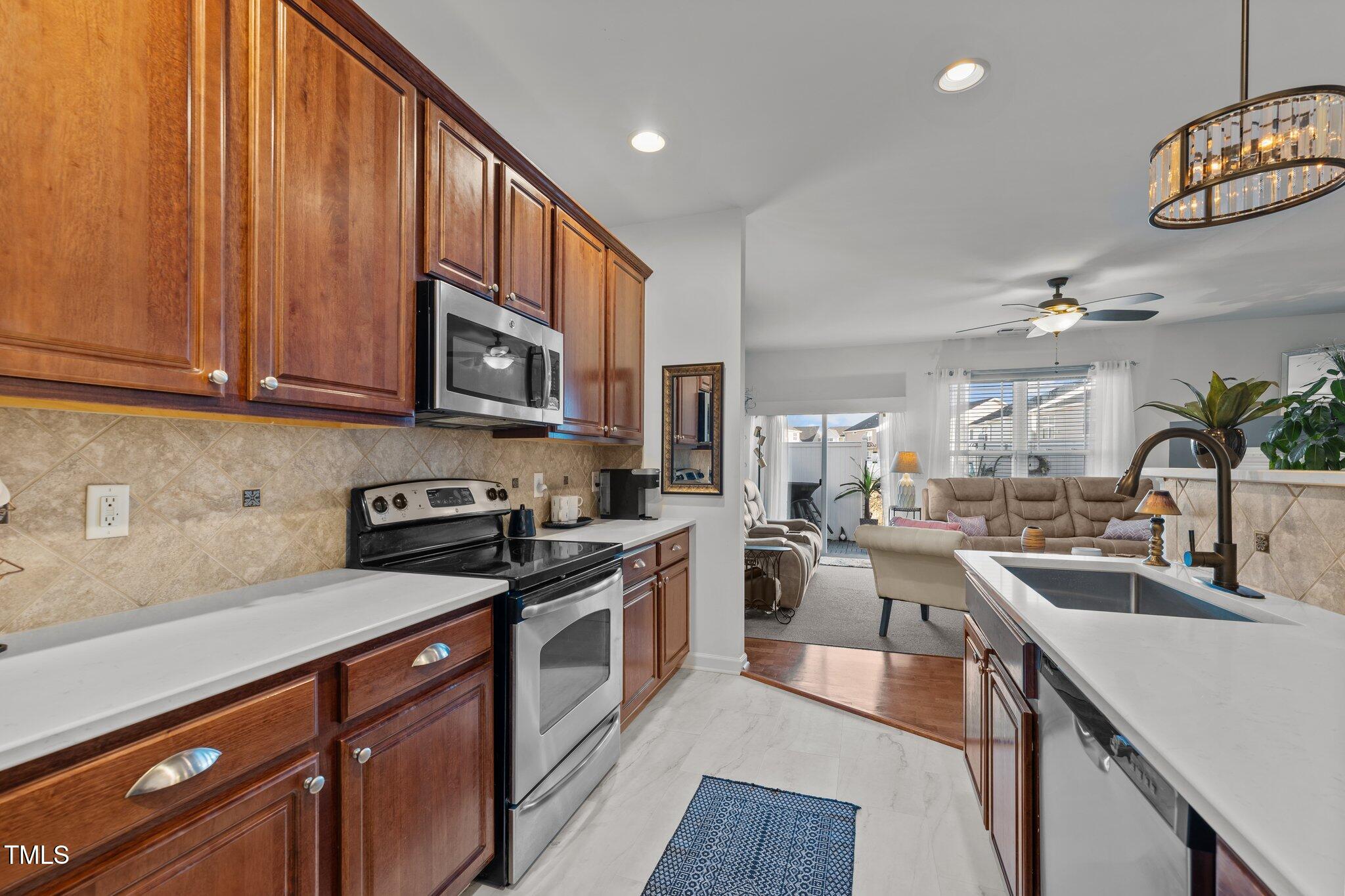 4027 Comrie Lane Burlington, NC 27215 - Photo 17 of 47 a kitchen with stainless steel appliances granite countertop a sink stove and refrigerator