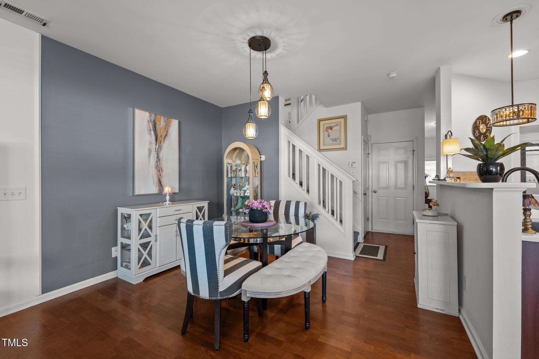 4027 Comrie Lane Burlington, NC 27215 - Photo 19 of 47 a view of a dining room with furniture and a chandelier