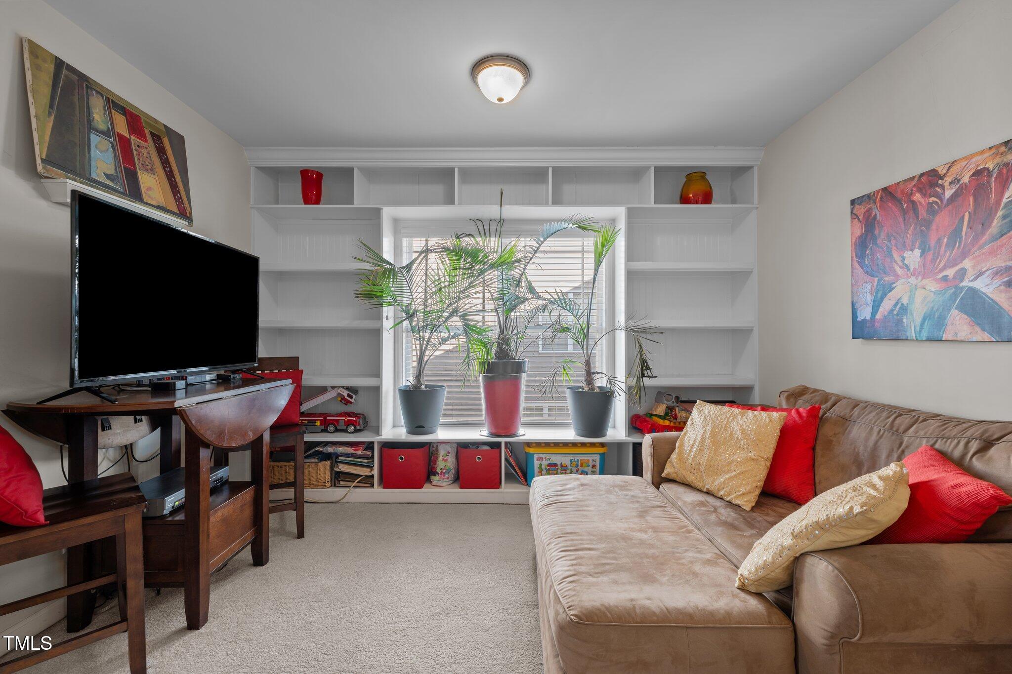 4027 Comrie Lane Burlington, NC 27215 - Photo 21 of 47 a living room with furniture and a flat screen tv