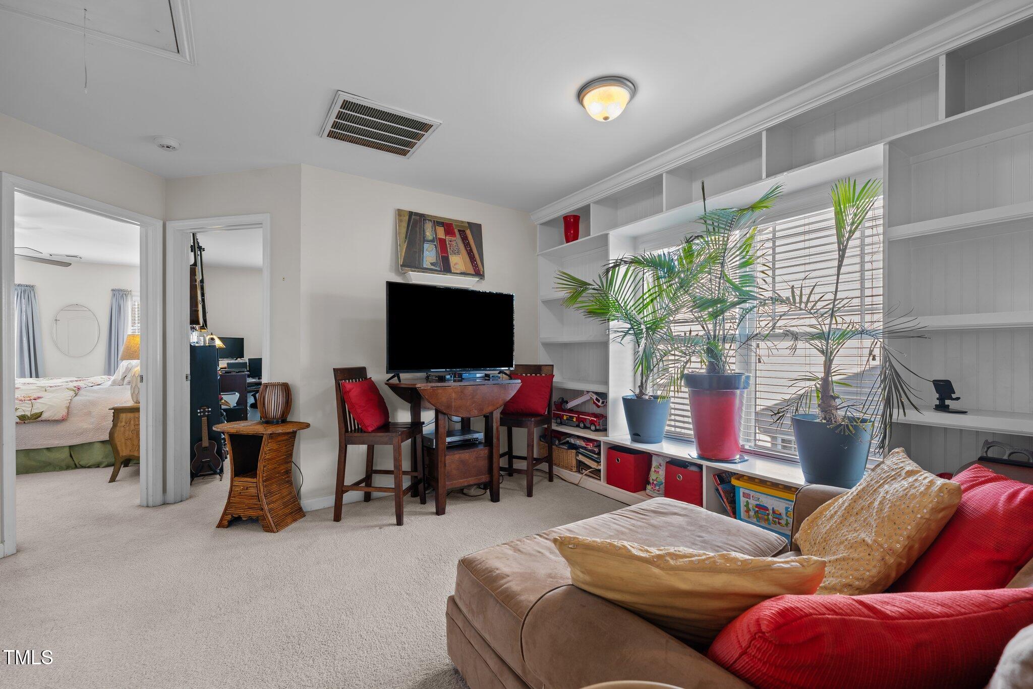 4027 Comrie Lane Burlington, NC 27215 - Photo 22 of 47 a living room with furniture and a flat screen tv