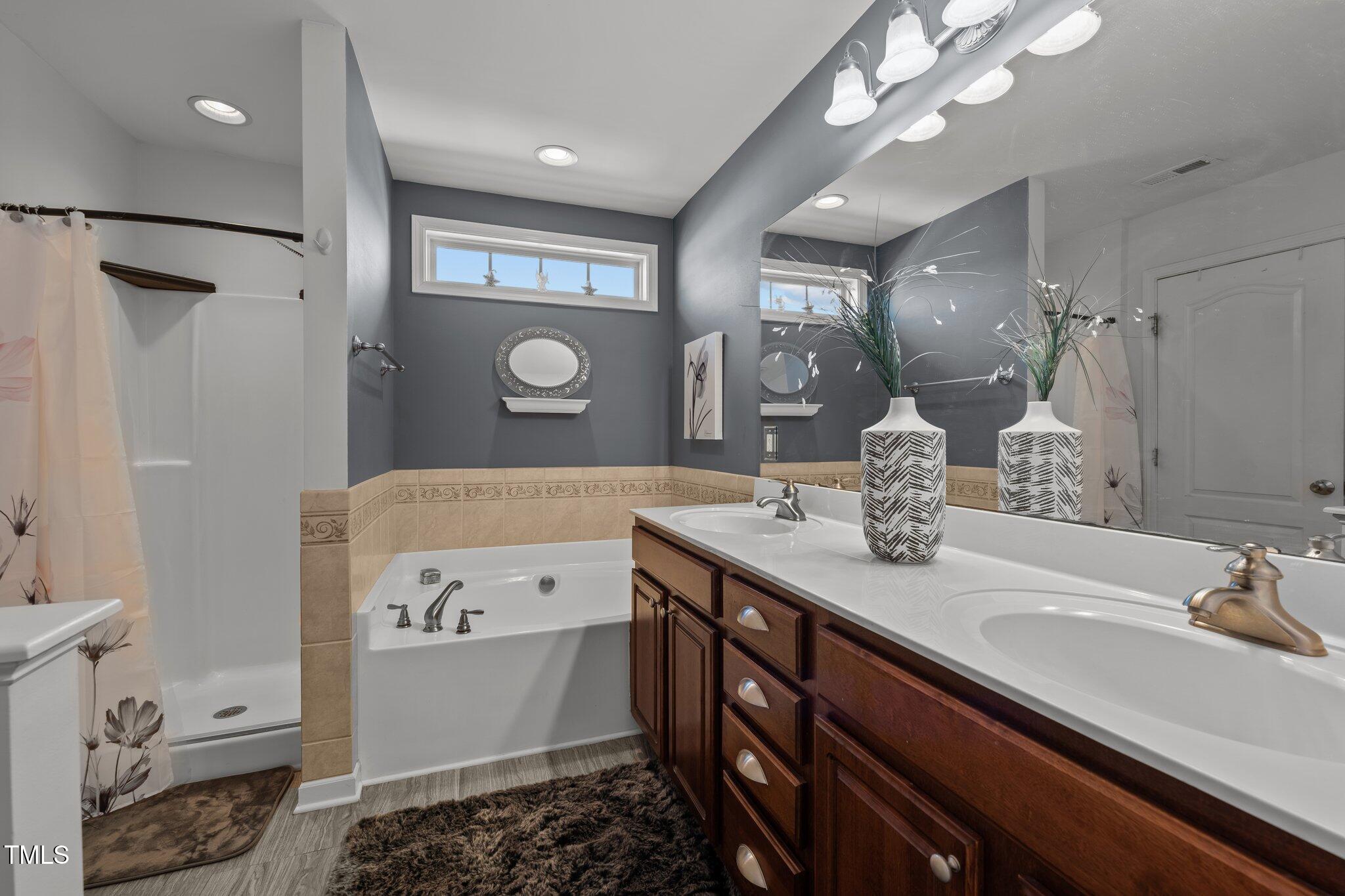 4027 Comrie Lane Burlington, NC 27215 - Photo 26 of 47 a bathroom with a sink a toilet and a mirror