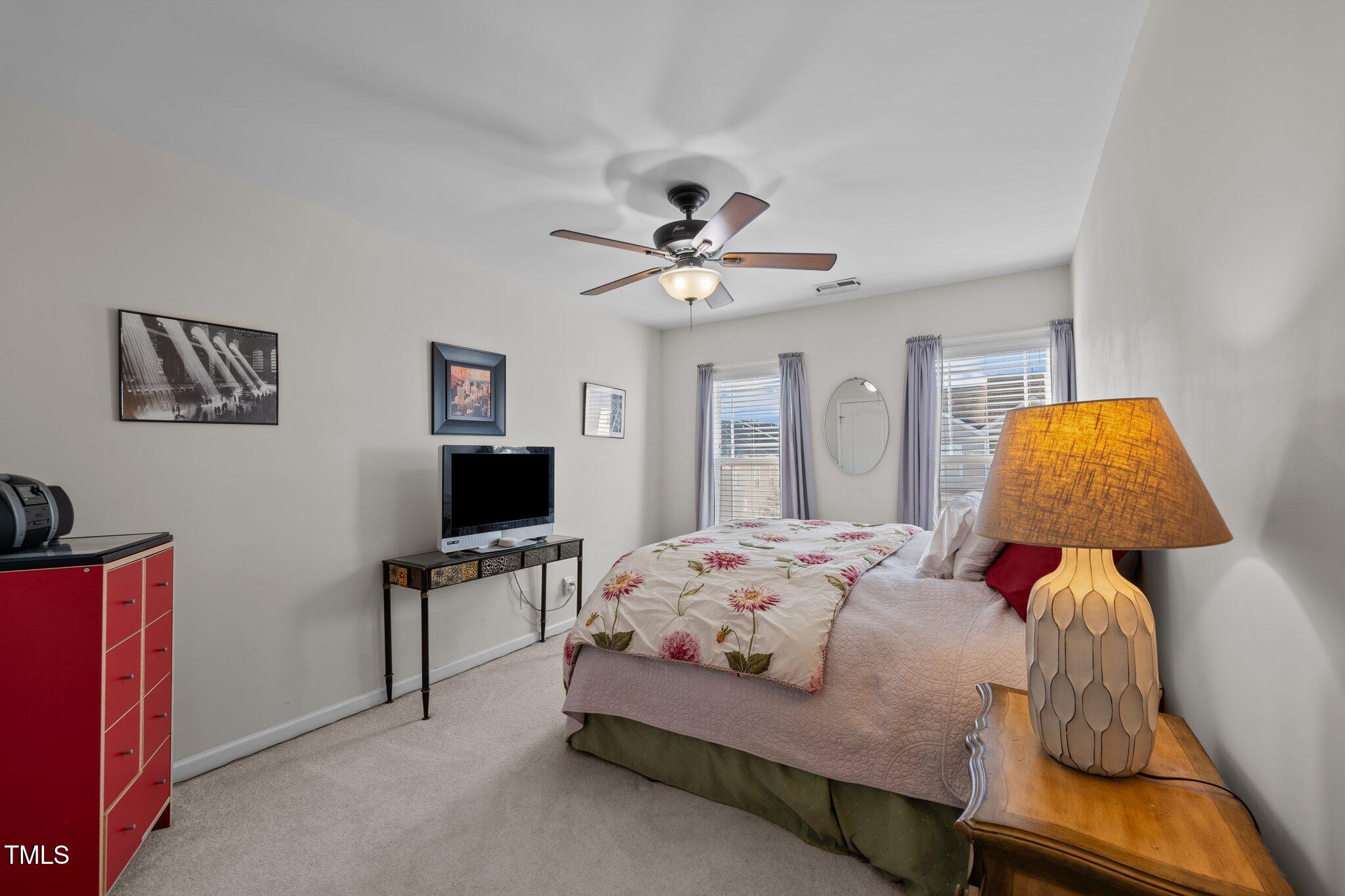 4027 Comrie Lane Burlington, NC 27215 - Photo 28 of 47 a bedroom with a bed and a chandelier