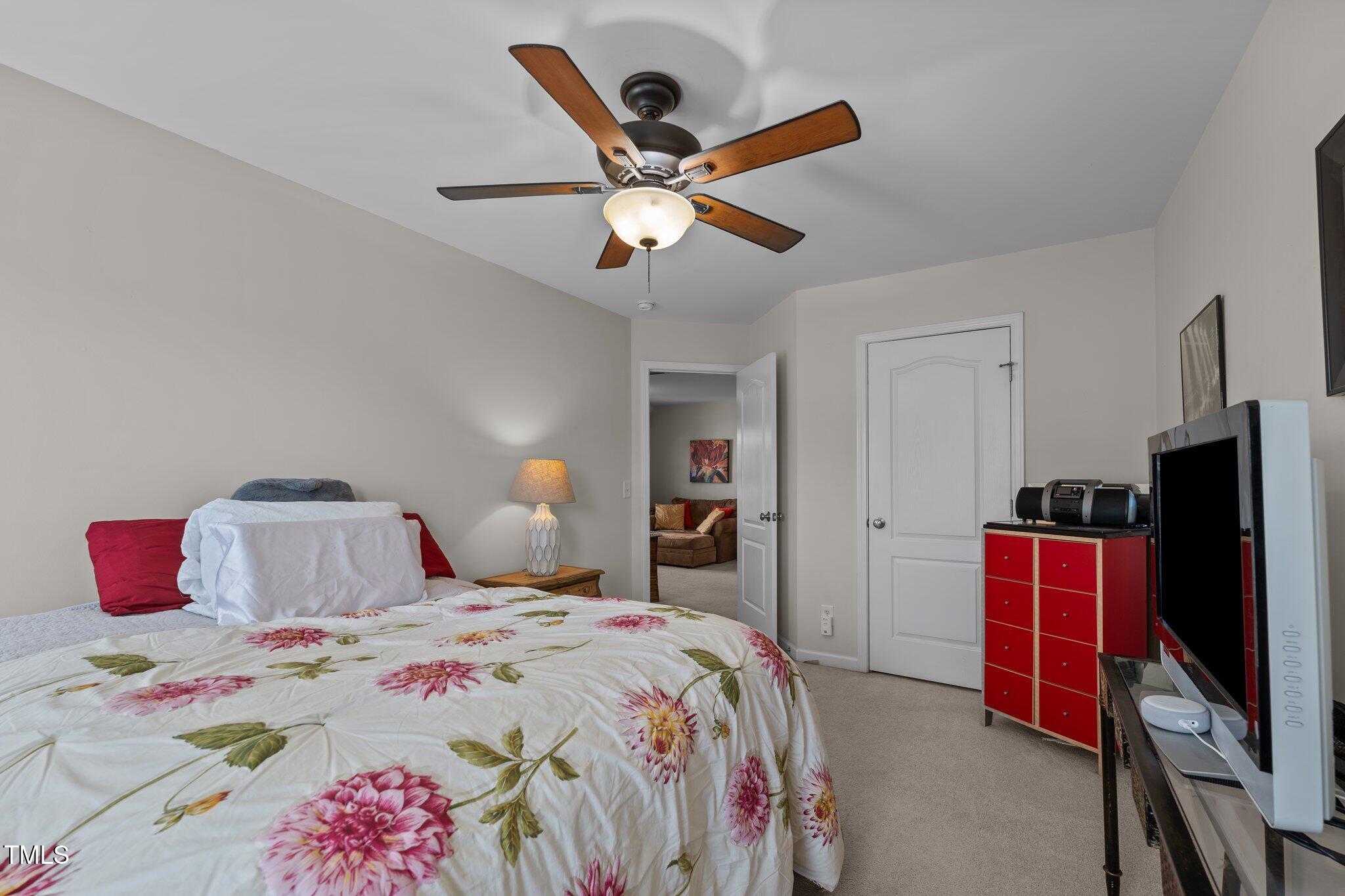 4027 Comrie Lane Burlington, NC 27215 - Photo 30 of 47 a bedroom with a bed and a chandelier
