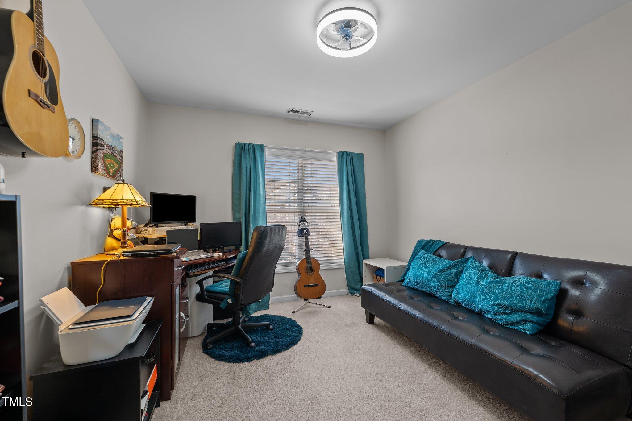 4027 Comrie Lane Burlington, NC 27215 - Photo 32 of 47 a living room with furniture a flat screen tv and a window