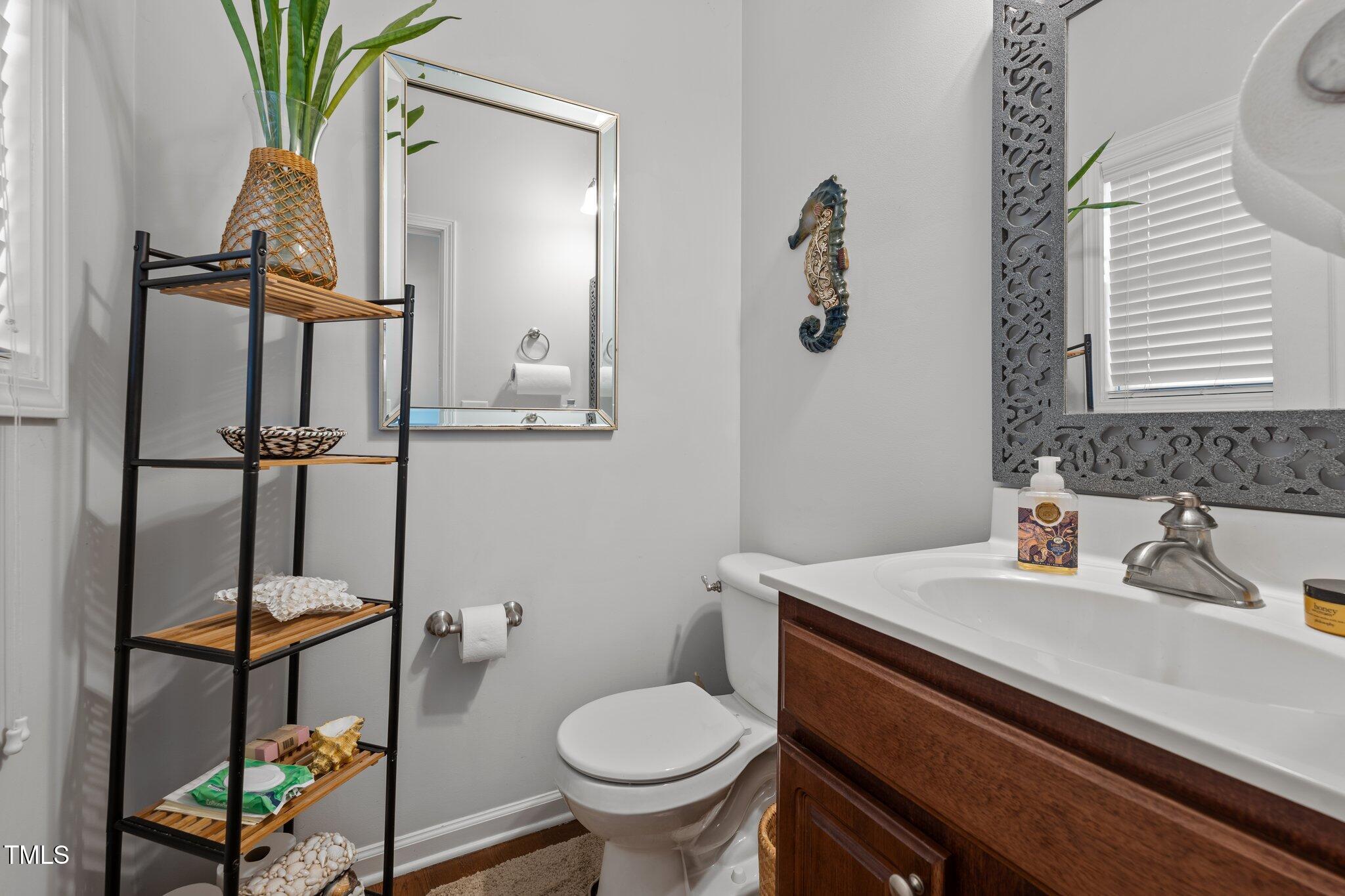 4027 Comrie Lane Burlington, NC 27215 - Photo 5 of 47 a bathroom with a sink toilet and a mirror