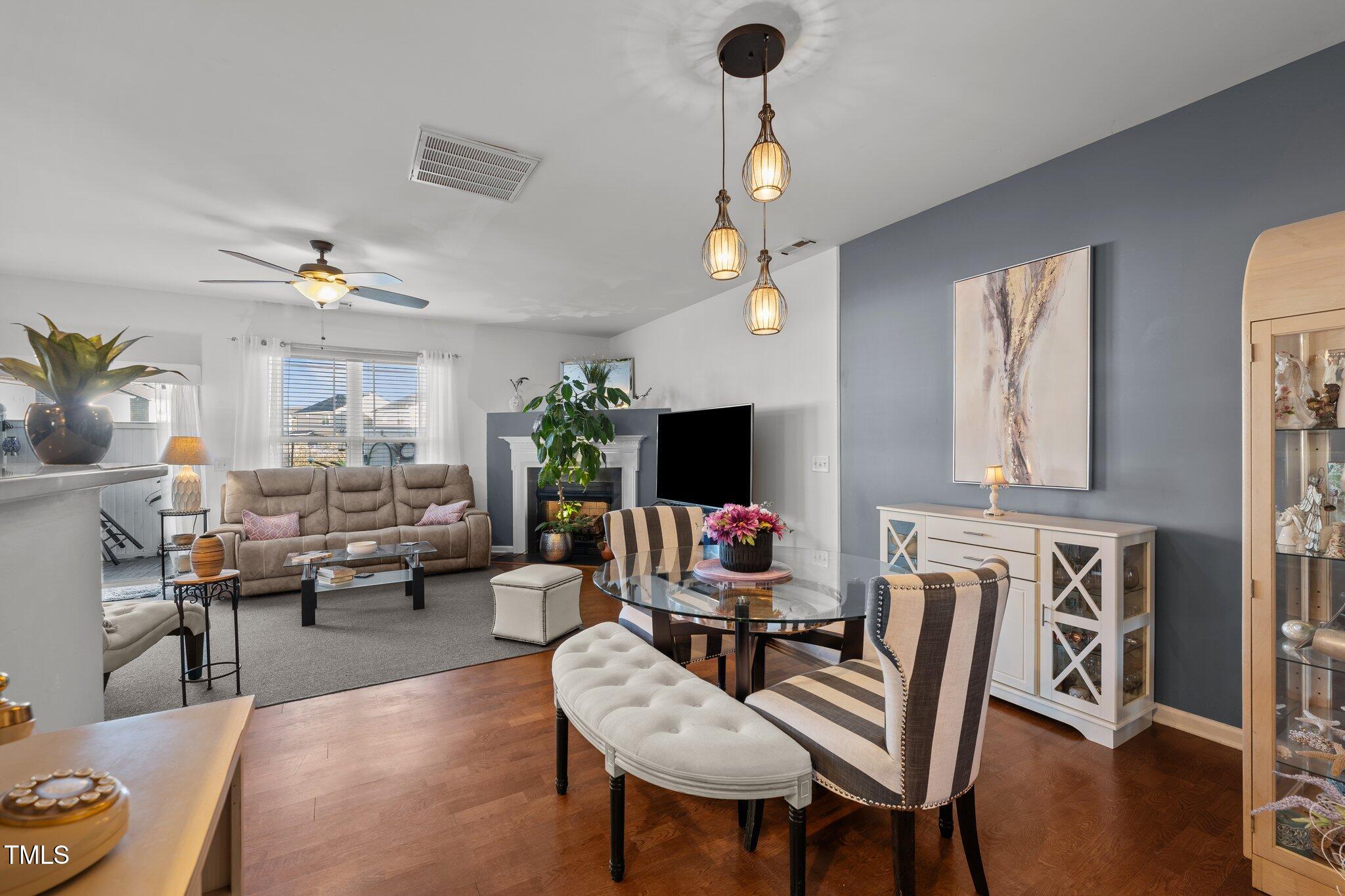 4027 Comrie Lane Burlington, NC 27215 - Photo 8 of 47 a living room with furniture and a chandelier