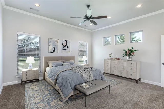 a bedroom with a bed chandelier and a window