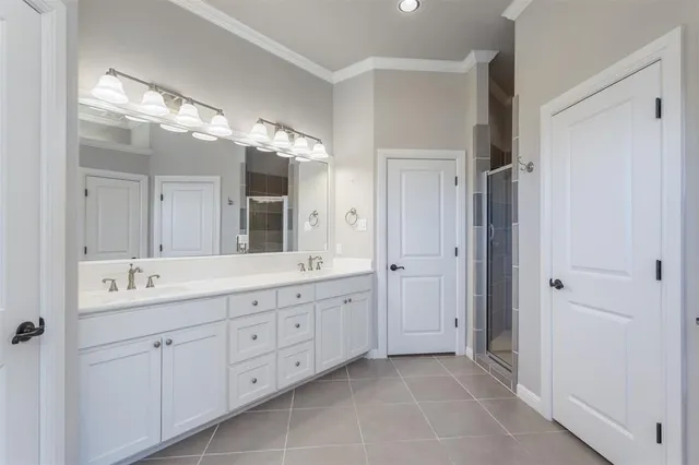 a spacious bathroom with a double vanity sink mirror and double