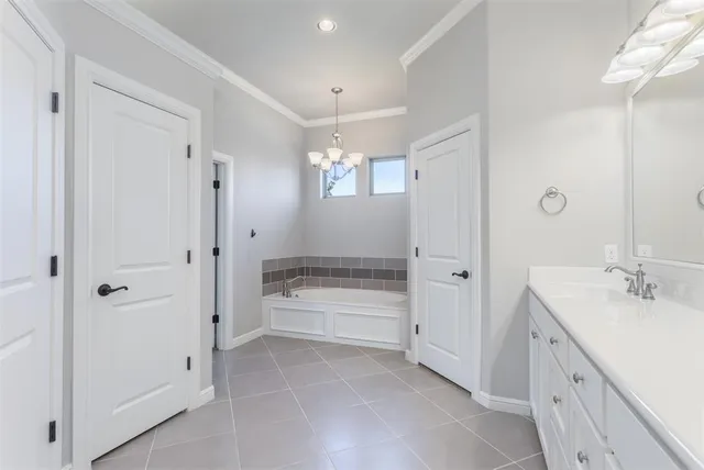 a bathroom with a double vanity sink a toilet and shower