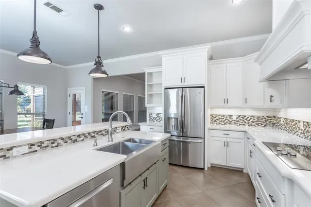 a kitchen with a sink stainless steel appliances and cabinets