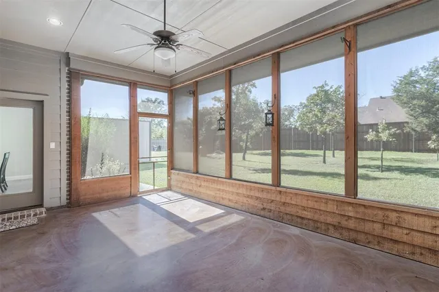a view of room with window and a ceiling fan