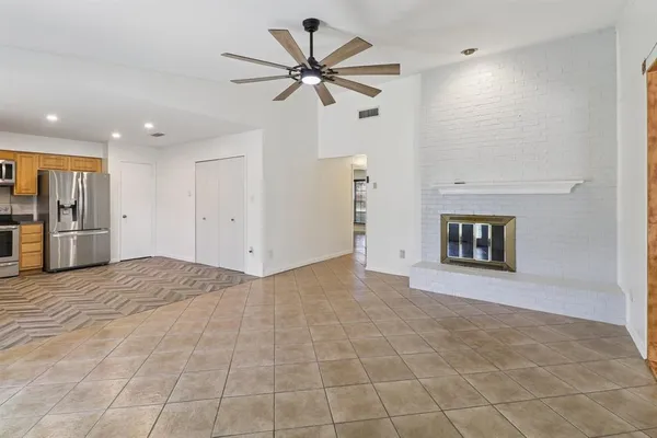 a kitchen with stainless steel appliances granite countertop a refrigerator sink and stove