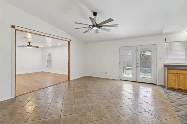 a view of an empty room with a ceiling fan