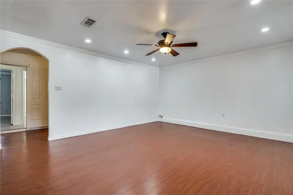 wooden floor in an empty room with a window