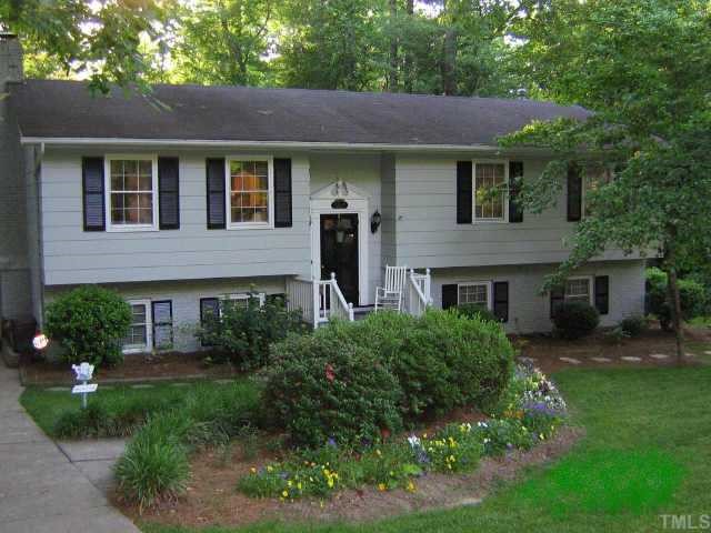 5017 Devonwood Court Raleigh, NC 27609 - Photo 1 of 1 a front view of a house with a yard and green space