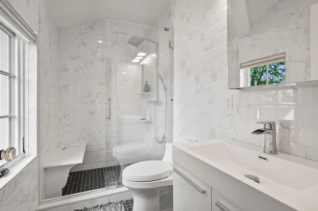 a bedroom with a large bed and a flat tv screen