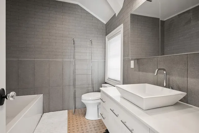 a view of a livingroom with furniture and a flat screen tv