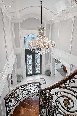 a view of a dining room with furniture a chandelier and wooden floor