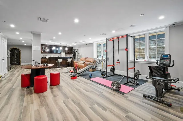 a dining room with furniture and a large window