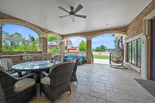 a view of a house with a backyard porch and sitting area