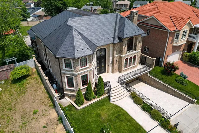 an aerial view of a house with garden space and street view