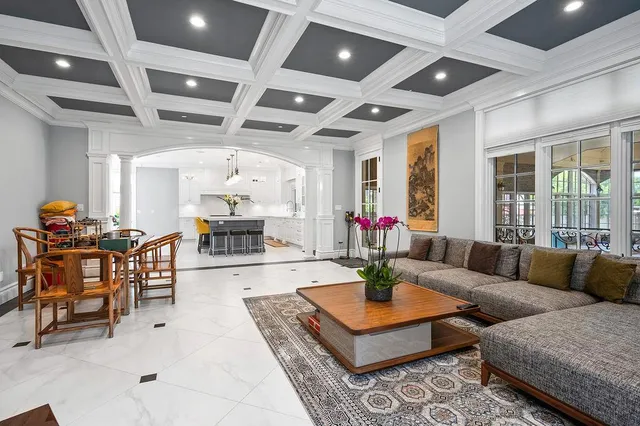 a kitchen with kitchen island granite countertop a table chairs sink and cabinets