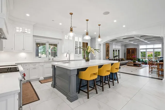 a large kitchen with a table and chairs in it
