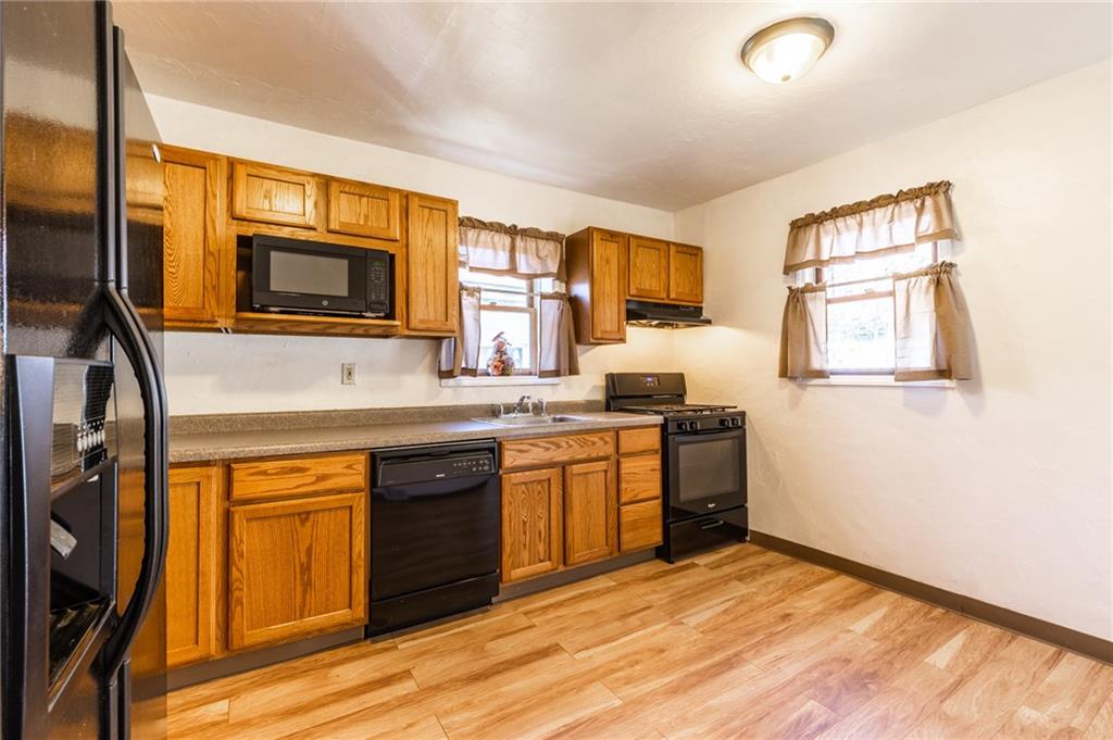 3260 Millers Run Road Cecil, PA 15321 - Photo 6 of 22 a kitchen with stainless steel appliances granite countertop a stove a sink and a microwave