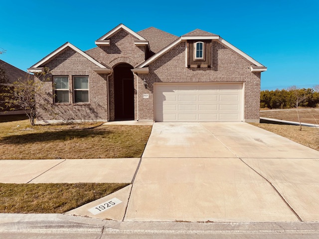 1925 Waterfall Avenue Leander, TX 78641 - Photo 1 of 17 a front view of a house with a yard