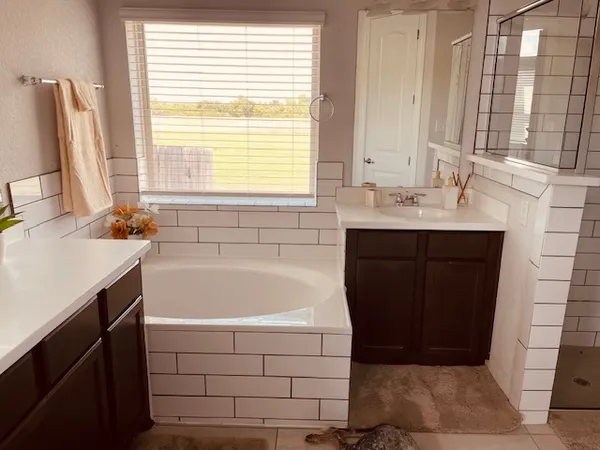 a bathroom with a bathtub sink and window