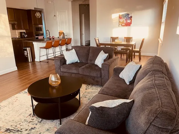 a living room with furniture and wooden floor