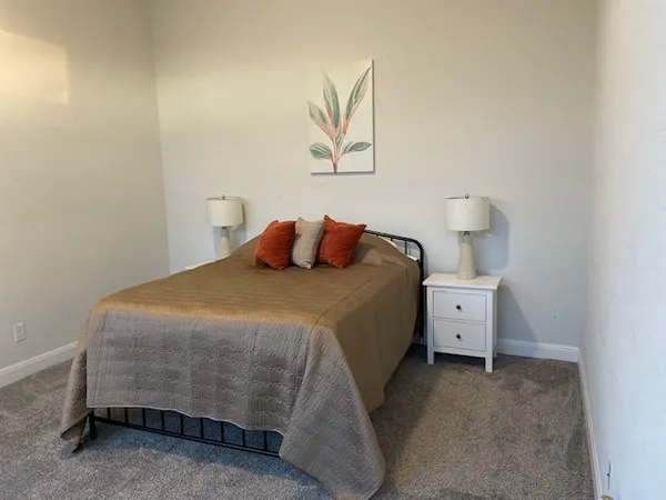 a bedroom with a bed and hallway