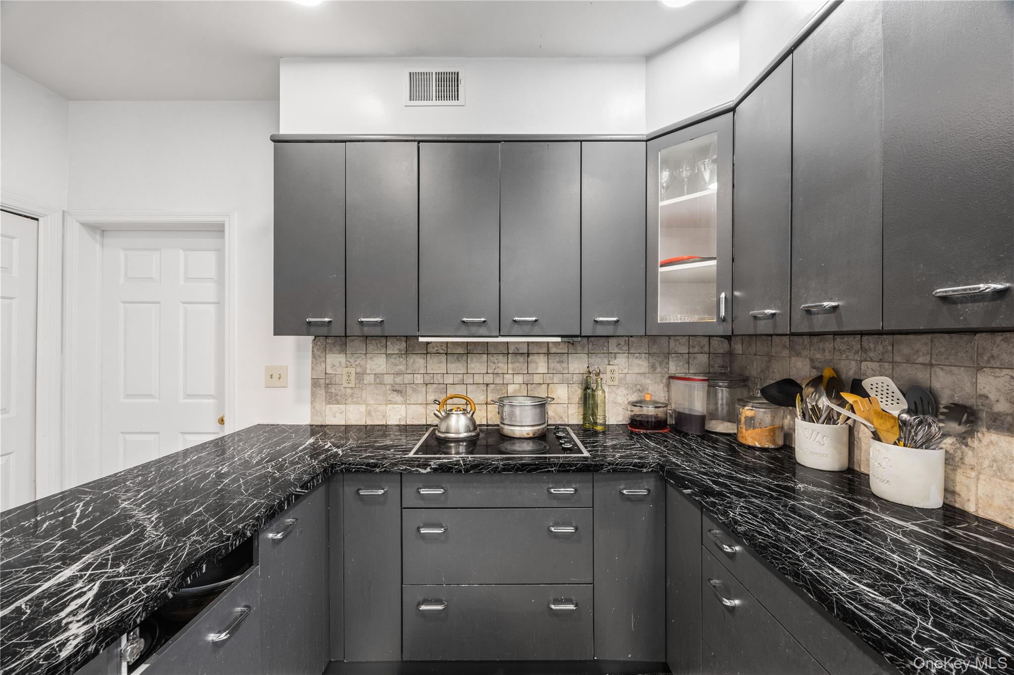 3 Miller Road Putnam Valley, NY 10579 - Photo 13 of 48 Kitchen featuring dark cabinetry, marble-finish countertops, built-in cooktop, tile backsplash, and overhead recessed lighting