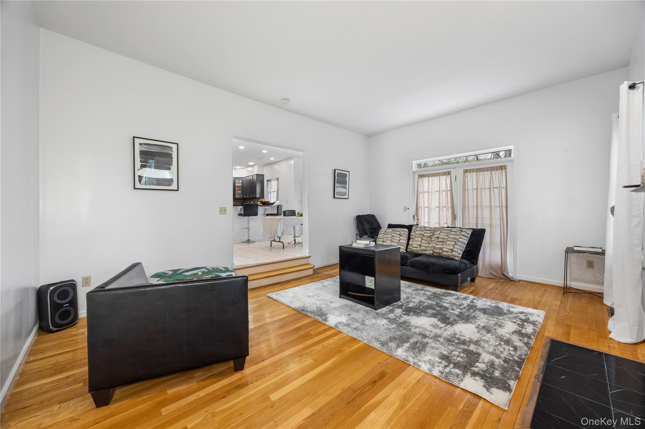 3 Miller Road Putnam Valley, NY 10579 - Photo 17 of 48 Spacious living area featuring polished wood-finish flooring, white walls, and a black tile hearth