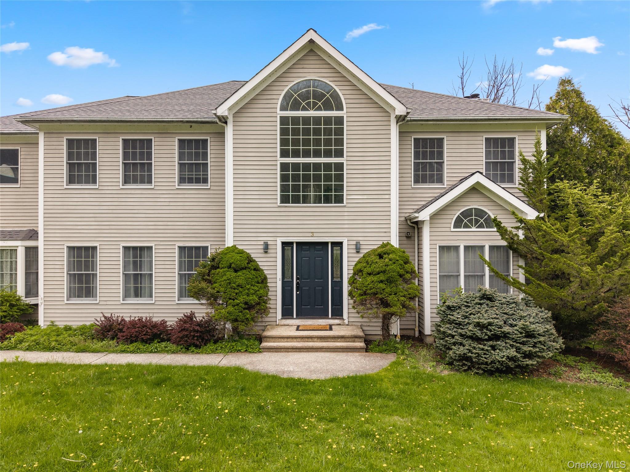 3 Miller Road Putnam Valley, NY 10579 - Photo 2 of 48 Two-story residence featuring light-toned siding, a prominent arched window, and multiple pane windows