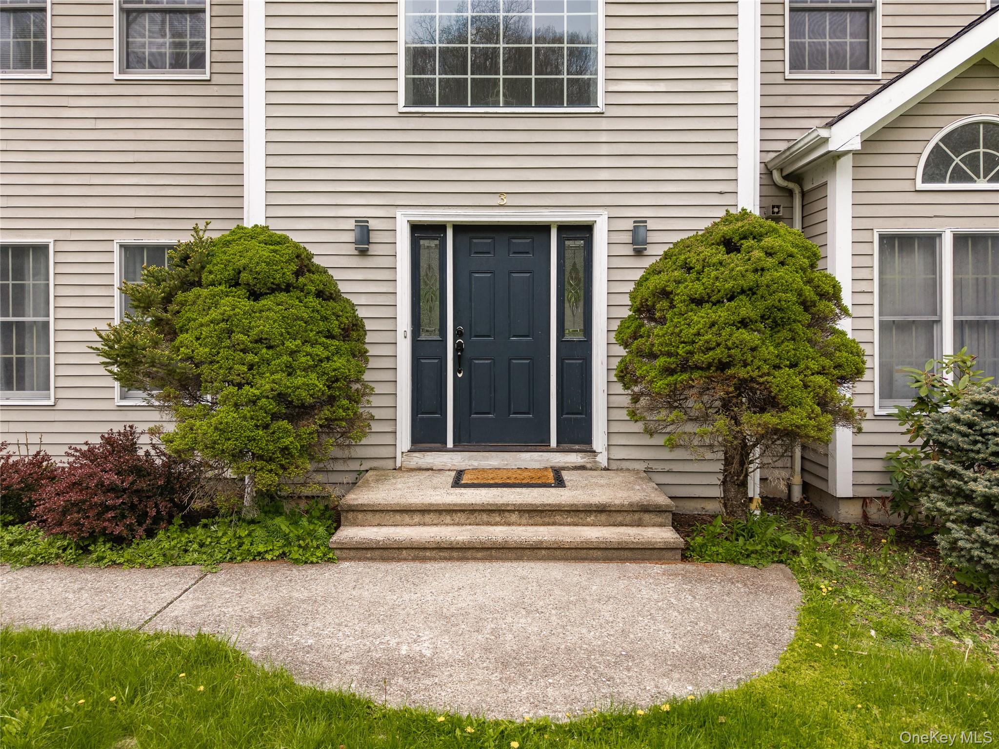 3 Miller Road Putnam Valley, NY 10579 - Photo 3 of 48 Stone steps ascend to a dark blue entry door with sidelight windows
