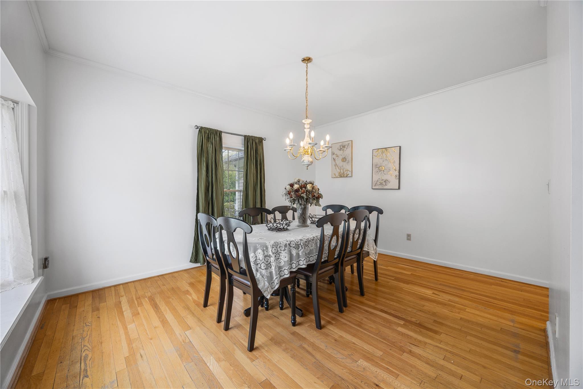 3 Miller Road Putnam Valley, NY 10579 - Photo 7 of 48 Dining area featuring natural wood-finish flooring, white walls, and a brass-tone chandelier