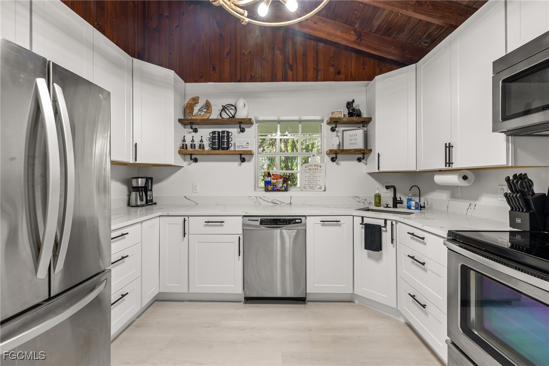 17780-800 Caloosa Road Alva, FL 33920 - Photo 22 of 42 a kitchen with stainless steel appliances granite countertop a refrigerator sink and stove