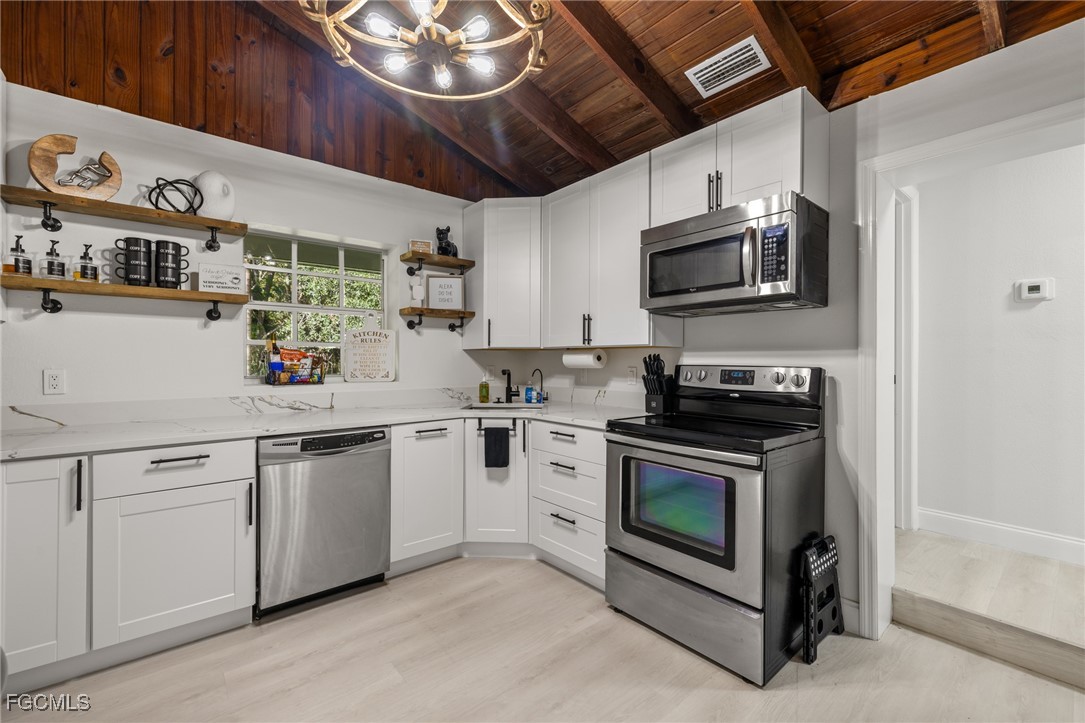 17780-800 Caloosa Road Alva, FL 33920 - Photo 23 of 42 a kitchen with stainless steel appliances granite countertop a stove and a sink