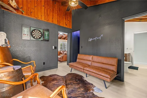 a living room with furniture a window and a potted plant