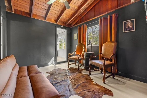 a bedroom with furniture and wooden floor