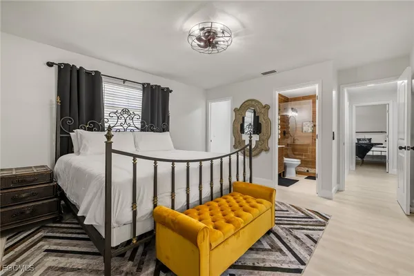 a bedroom with a bed and a chandelier