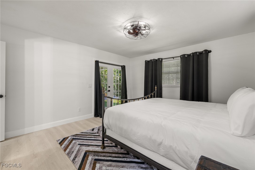 17780-800 Caloosa Road Alva, FL 33920 - Photo 32 of 42 a bedroom with a bed and a chandelier