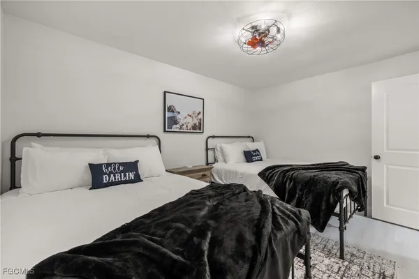 a bedroom with two beds and a desk