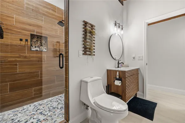 a bathroom with a sink a toilet and a mirror