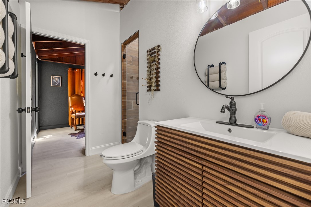 17780-800 Caloosa Road Alva, FL 33920 - Photo 40 of 42 a bathroom with a sink a toilet and a mirror