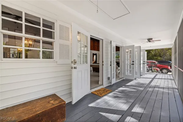 a view of a balcony with wooden floor and fence