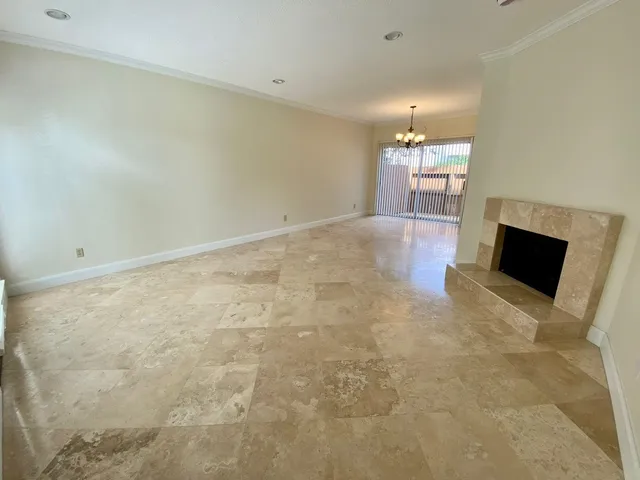 en empty room with window and fireplace