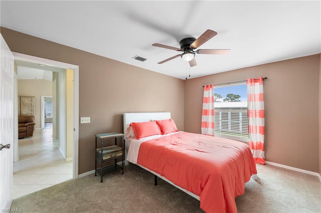 18435 Heather Road Fort Myers, FL 33967 - Photo 20 of 34 Carpeted room featuring a ceiling fan with integrated lighting, a window with horizontal blinds, and neutral wall tones